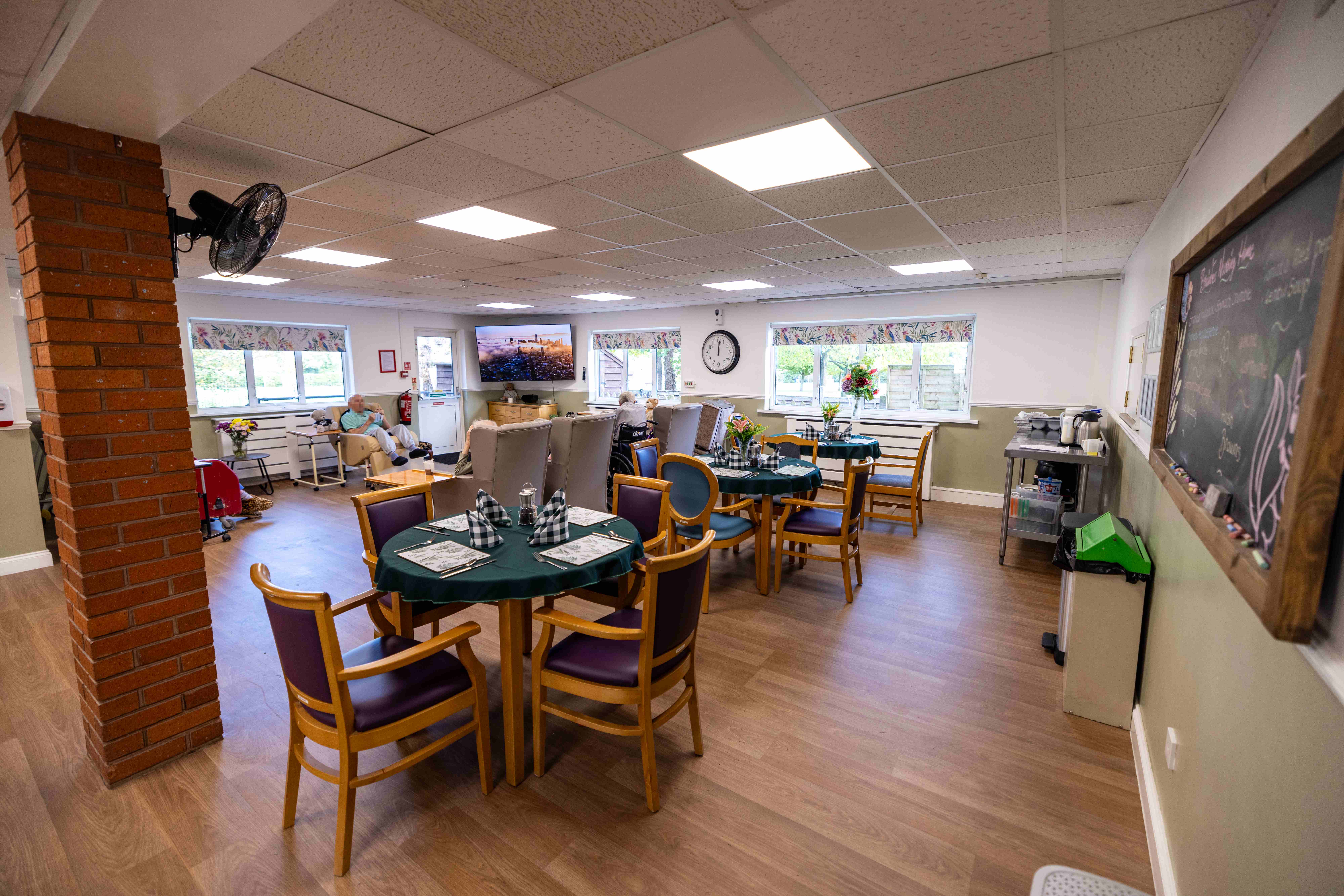 Dining area with round tables and chalkboard menu